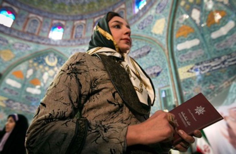 Iranian woman waits to vote