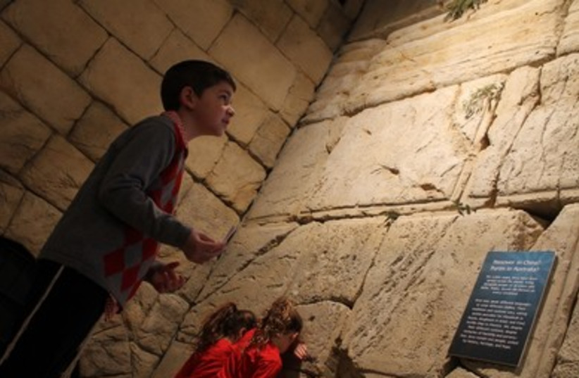 Children stand at  the model Western Wall