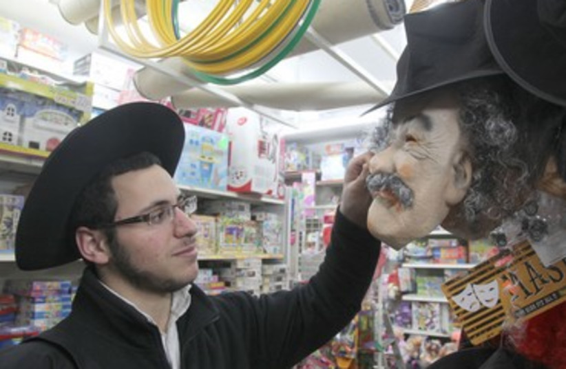 Haredi teen looks for Purim mask in Mea Shearim