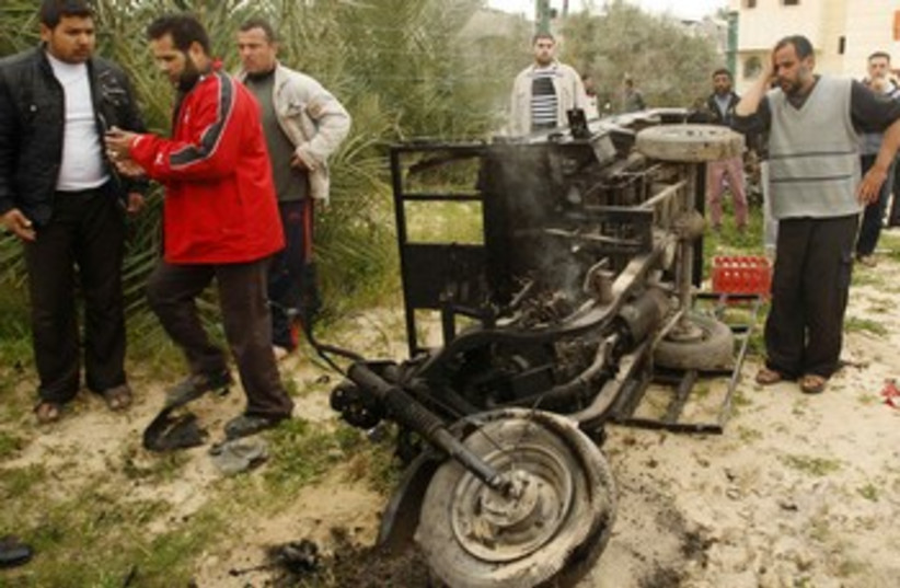 Palestinians examine destroyed rickshaw
