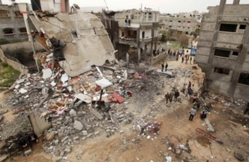 Palestinians gather at building destroyed by air strike