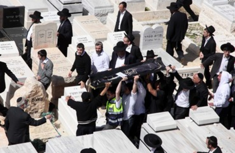 Miriam Monsonego's body is carried through cemetery