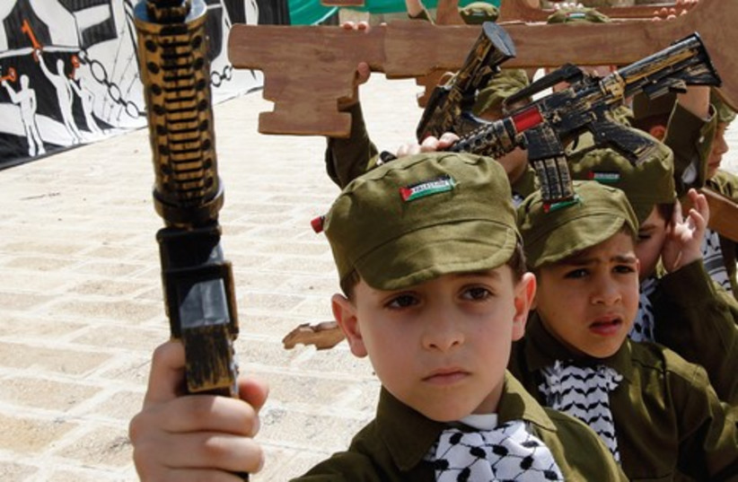 Palestinian children dressed as soldiers 521 (credit: Reuters)