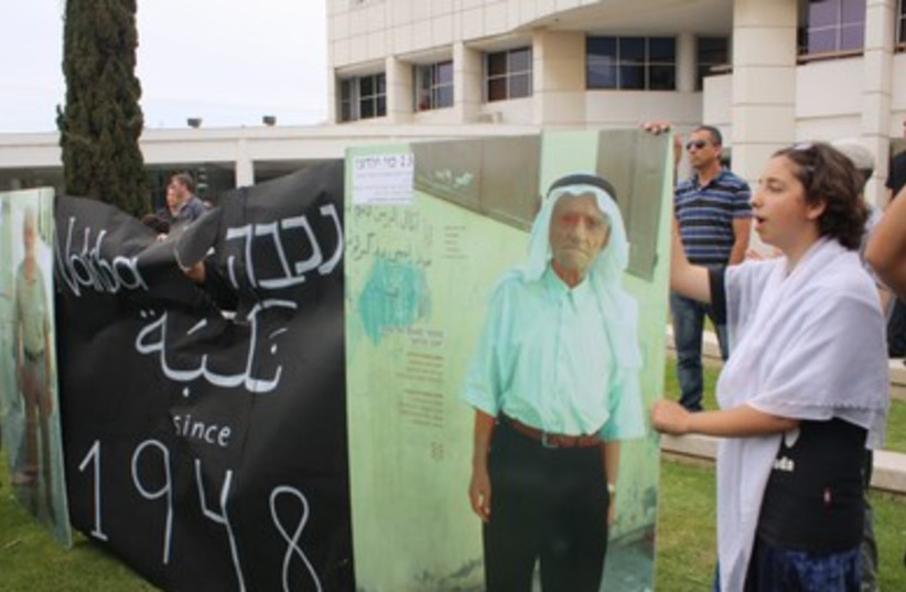 Nakba Day students hold up signs