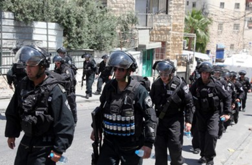 Israeli security forces line up at Isawiya