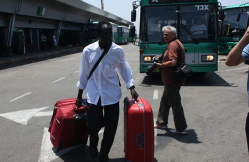 South Sudanese man with suitcases prior to deportation