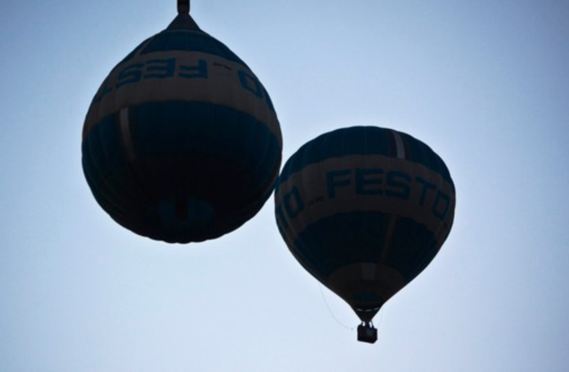A hot air balloon (L), designed to look as if it is floating