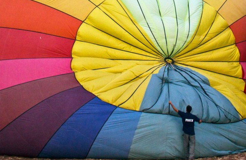 A man prepares a hot air balloon before it takes flight