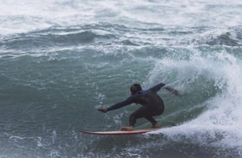 A man surfs off the coast of Tel Aviv 370