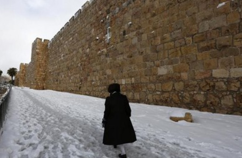 An ultra-Orthodox man walks past the Old City 390