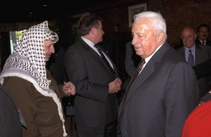 Ariel Sharon with former Palestinian leader Yasser Arafat.
