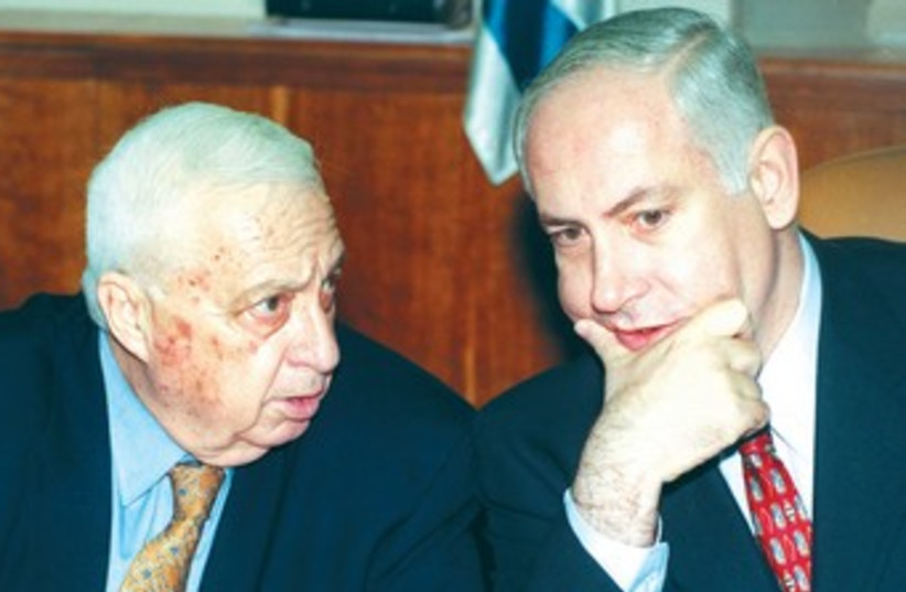 PM Binyamin Netanyahu and defense minister Ariel Sharon talk during a cabinet meeting in 1999.