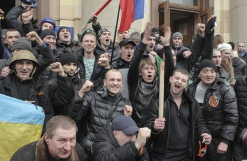 Pro-Russian protesters celebrate after clashes with pro-government forces in Kharkiv.