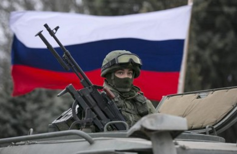 A Russian army vehicle stands outside a Ukrainian guard post in the Crimean town of Balaclava.