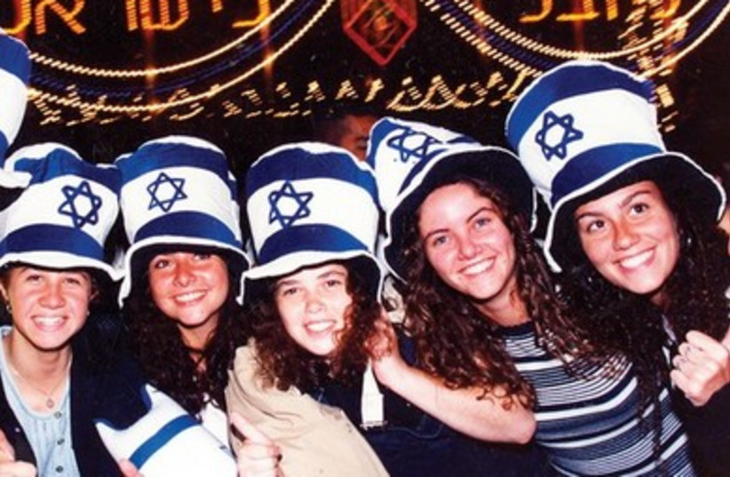 YOUNG REVELERS take part in Israel’s 50th Independence Day. 