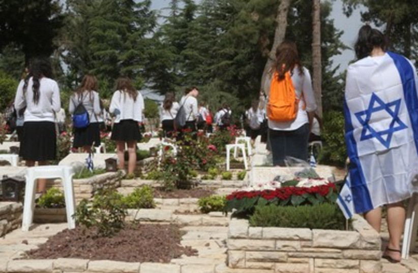 Israelis gather at the military cemetery on Mt. Herzl to pay respects to fallen loved ones.