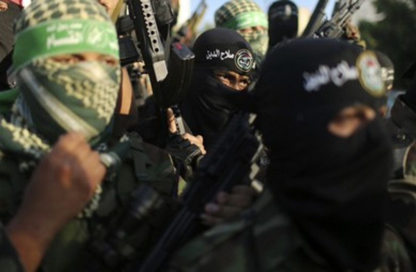 Palestinians militants from various armed factions, including Hamas, attend a news conference in Gaza City.