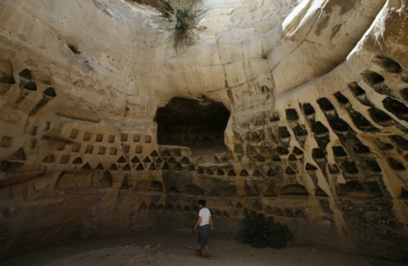 A tourist visits Hirbet Madras archaeological site, featuring ancient rebel hideouts, at the foothills of Jerusalem around the ancient city of Beit Guvrin August 23, 2011