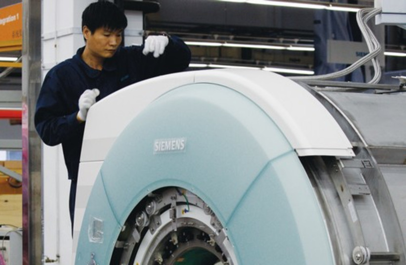 An MRI machine being assembled (credit: REUTERS)