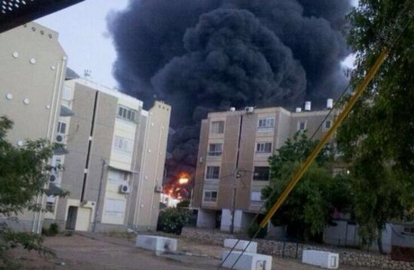 Sderot factory catches fire after being hit by a rocket from Gaza.