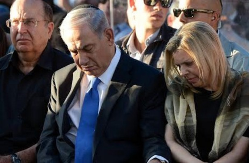 Prime Minister Binyamin Netanyahu and his wife Sara at the funeral for three murdered teens.