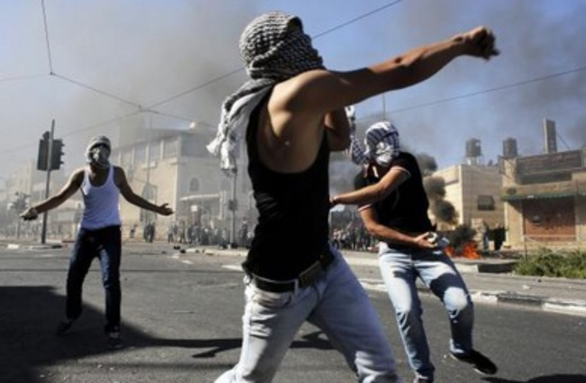 Palestinian stone-throwers clash with Israeli police in Shuafat.