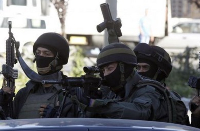 Israeli riot police take positions in the east Jerusalem neighborhood of Shuafat.