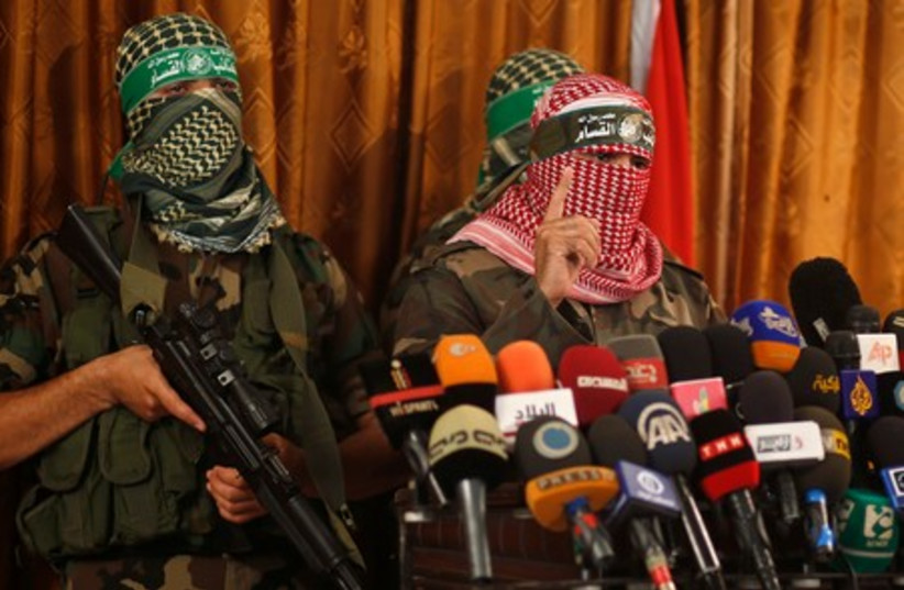 Hamas' armed wing spokesman speaks during a news conference in Gaza City July 3, 2014.