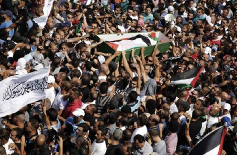 Palestinians carry the body of 16-year-old Muhammad Abu Khdeir during his funeral in Shuafat, an Arab suburb of Jerusalem.