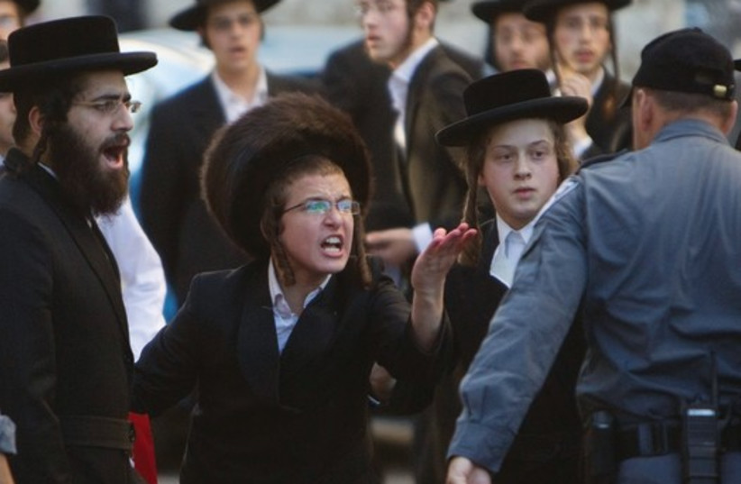 Haredim take part in a protest in Mea She’arim against the municipality opening a nearby road on Shabbat. (credit: REUTERS/BAZ RATNER)
