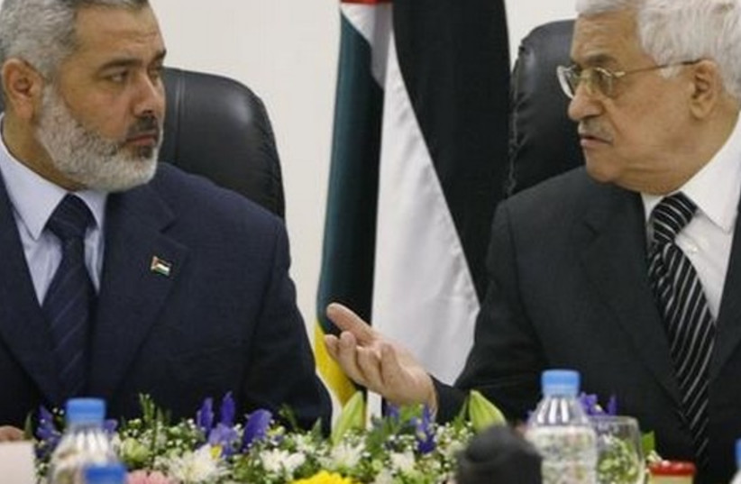 Palestinian Authority President Mahmoud Abbas (R) talks with Hamas leader Ismail Haniyeh. (credit: REUTERS)