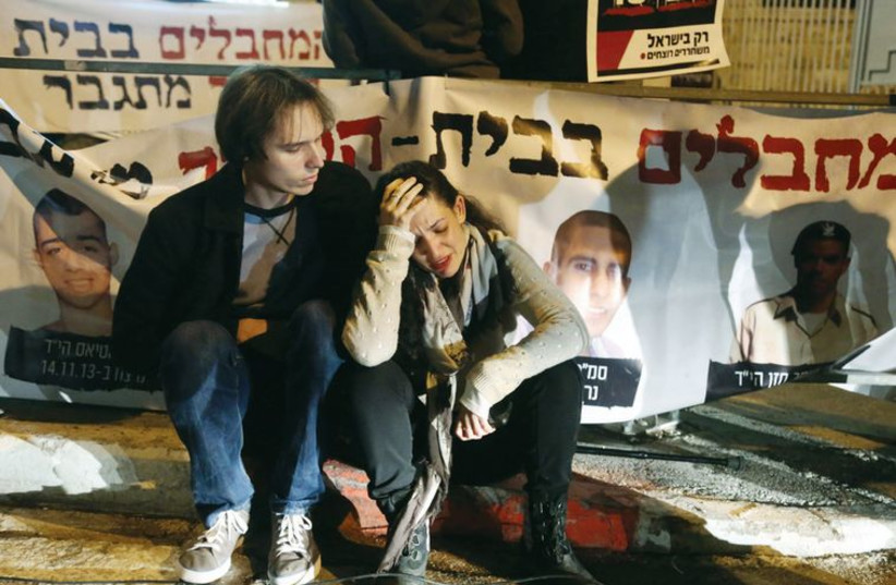 Israelis who lost family members in terror attacks break down during a protest against the release of prisoners