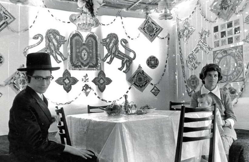 Members of the Alboim family, who won the Jerusalem beautiful succa contest, sit in their succa in 1974.