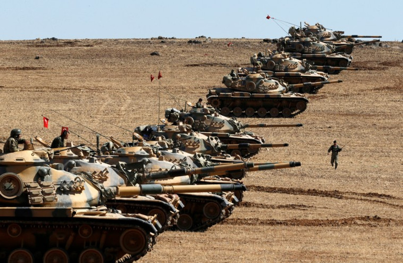 Turkish army tanks take up position on the Turkish-Syrian border near the southeastern town of Suruc in Sanliurfa province (credit: REUTERS)