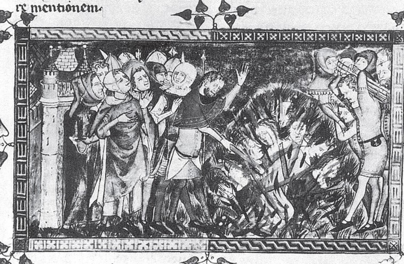 A MEDIEVAL MANUSCRIPT shows Jews burned at the stake in Flanders according to the popular antidote to the Black Death. (credit: Wikimedia Commons)