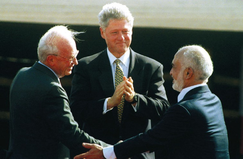 Prime ministers Yitzhak Rabin and US president Bill Clinton congratulate Jordan’s King Hussein after his speech at the Israeli-Jordanian peace treaty signing ceremony on October 26, 1994. (credit: REUTERS)