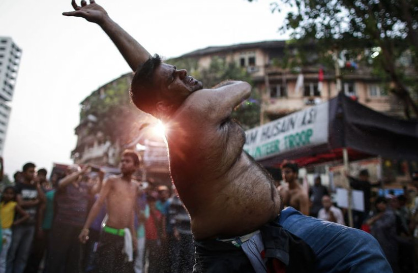 A Shi'ite Muslim flagellates himself during a Muharram procession to mark Ashoura in Mumbai November 4, 2014.
