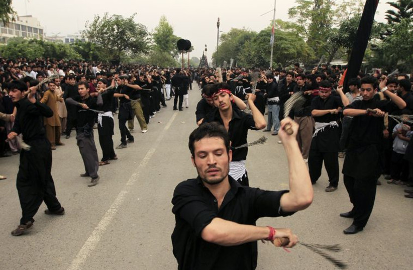 Pakistani Shi'ite Muslim men flagellate themselves during a Muharram procession in Islamabad, Pakistan, November 3, 2014.