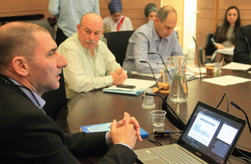 Finance Ministry chief economist Yoel Naveh (left) speaks to the Knesset Finance Committee in Jerusalem (credit: KNESSET)