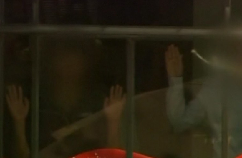 Hands pressed up against the window of Sydney's Lindt cafe, where hostages are being held