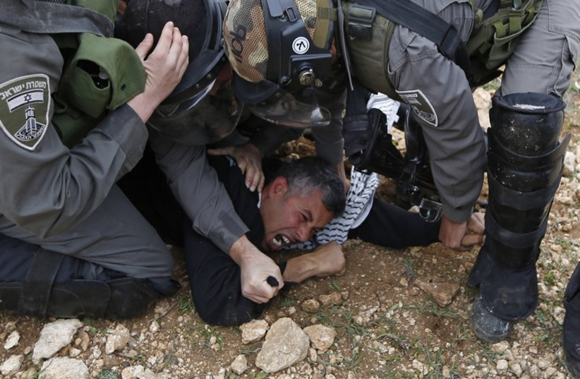 Israeli border police detain a Palestinian protester during clashes following a demonstration near Ramallah