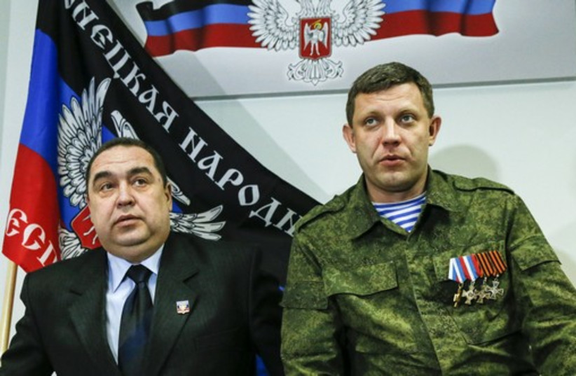 Alexander Zakharchenko (R), leader of the self-proclaimed Donetsk People's Republic (DPR), and Igor Plotnitsky, leader of the self-proclaimed Luhansk People's Republic (LPR), attend a news conference in Donetsk February 2 (credit: REUTERS)