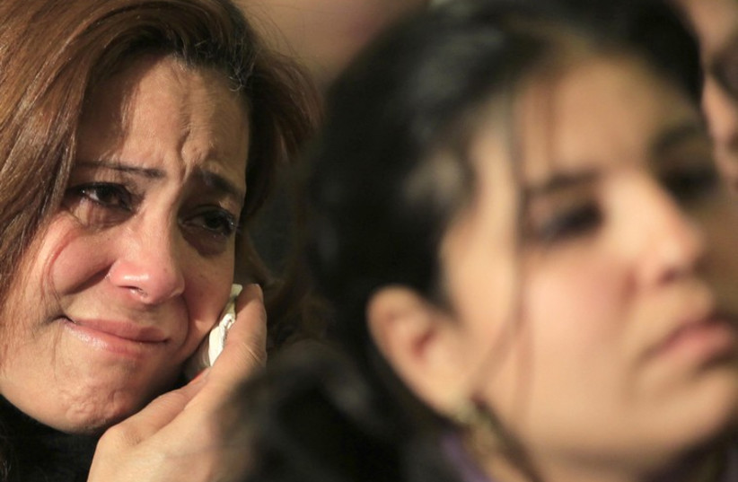 A Coptic Christian cries at Coptic mass prayers for Egyptians beheaded in Libya, at Saint Mark's Coptic Orthodox Cathedral in Cairo.