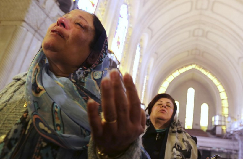 Coptic Christian women attend at the Coptic mass prayers for the Egyptians beheaded in Libya, at Saint Mark's Coptic Orthodox Cathedral in Cairo.