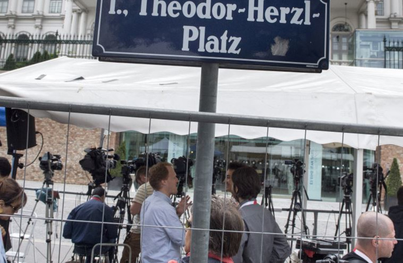 Journalists and television crews wait outside the Palais Coburg Hotel located at Theodor-Herzl square where the Iran nuclear talks meetings are being held in Vienna, Austria on July 13, 2015.