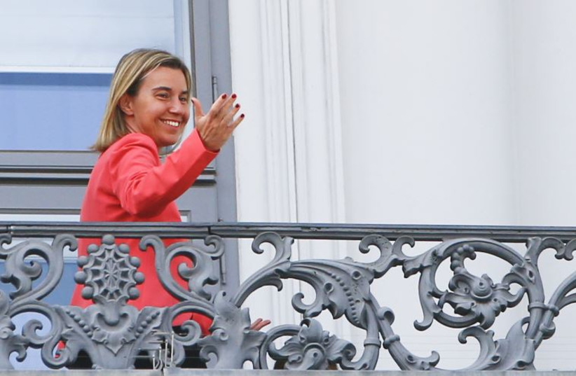 European Union foreign policy chief Federica Mogherini gestures as she stands on the balcony of Palais Coburg, the venue for nuclear talks in Vienna, Austria, July 13, 2015.