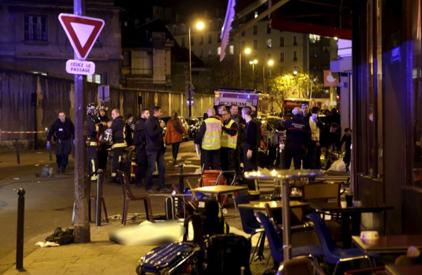 A general view of the scene that shows the covered bodies outside a restaurant following a shooting incident in Paris, France, November 13, 2015