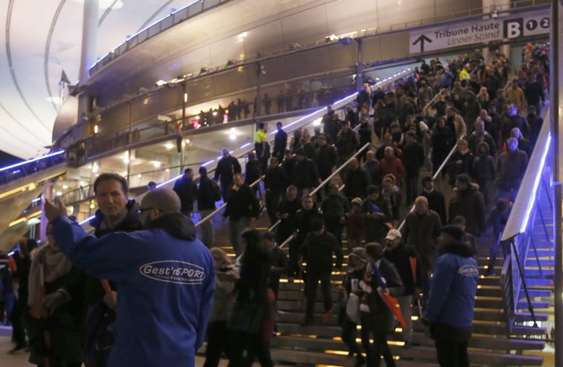 Crowds leave the Stade de France where explosions were reported to have detonated outside the stadium during the France vs German friendly match near Paris, November 13, 2015