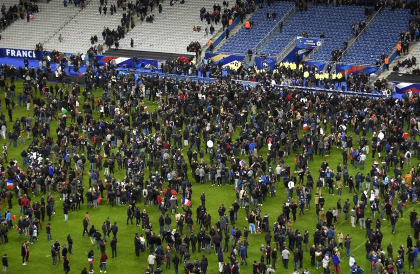 Soccer fans wait for security clearance to leave the Stade de France in Saint-Denis, north of Paris, after the friendly football match France vs Germany on November 13, 2015