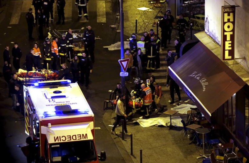 Rescue service personnel working outside a restaurant following shooting incidents in Paris, France, November 13, 2015